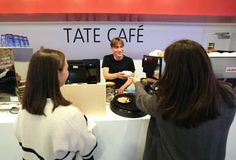 Two visitors being served at the Tate Liverpool + RIBA North cafe