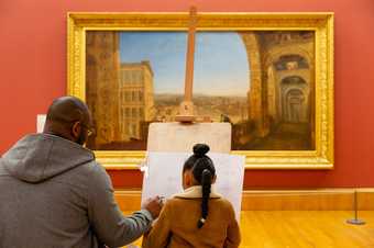 a parent and child draw on an easel in Tate Britain