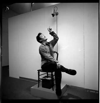 black and white photo of man on chair