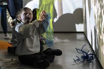 A young person with plays with different tactile items.